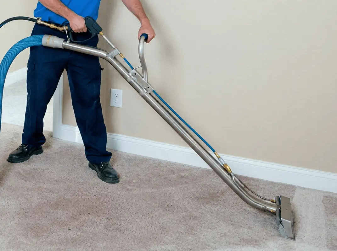 Professional operating a liquid removal machine on a carpeted floor in Richmond, VA