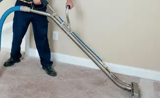 Professional operating a liquid removal machine on a carpeted floor in Richmond, VA
